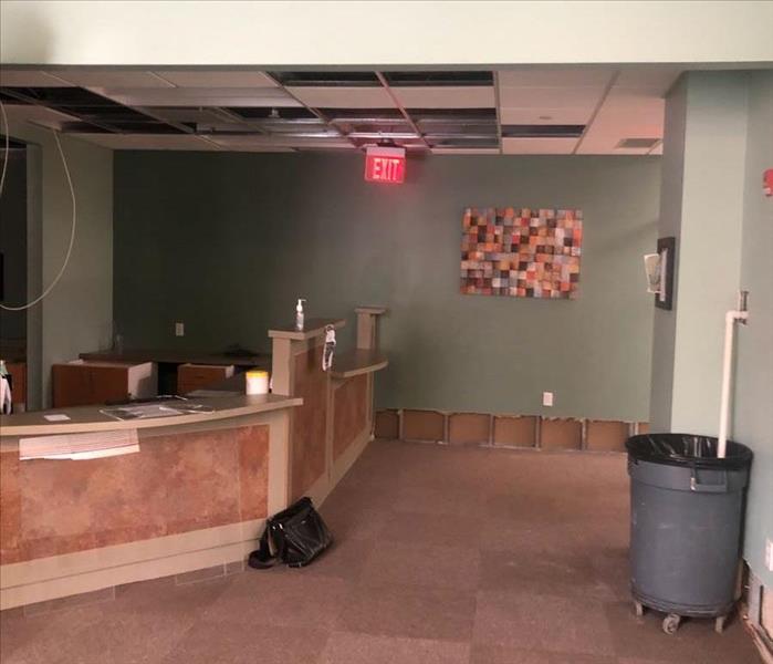 Front desk with exposed floor and flood cut wall 