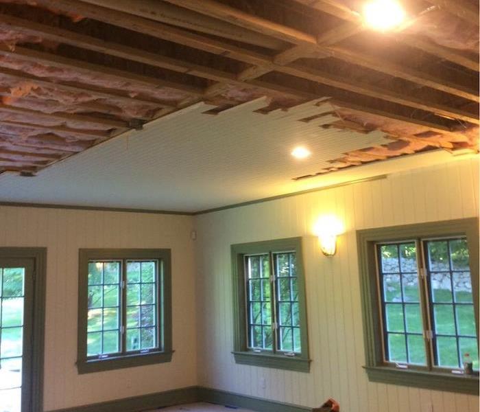 Family room with ceiling and floor removed with water extraction equipment