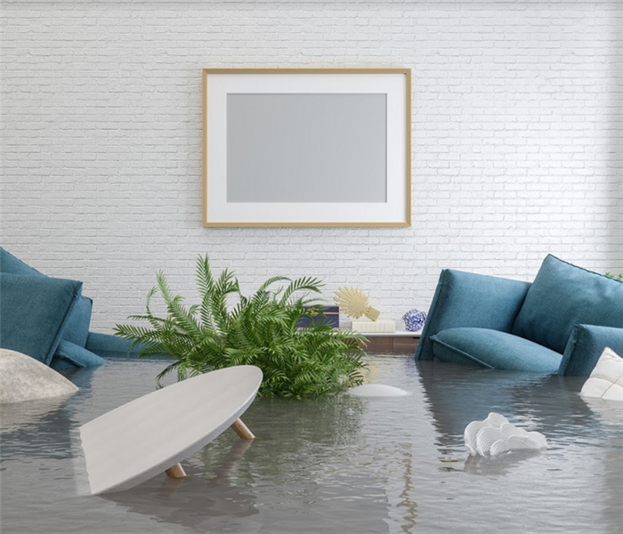 flooded interior of a living room with furniture floating