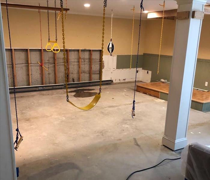 Gym in basement with water line cuts to prevent anymore water damage.